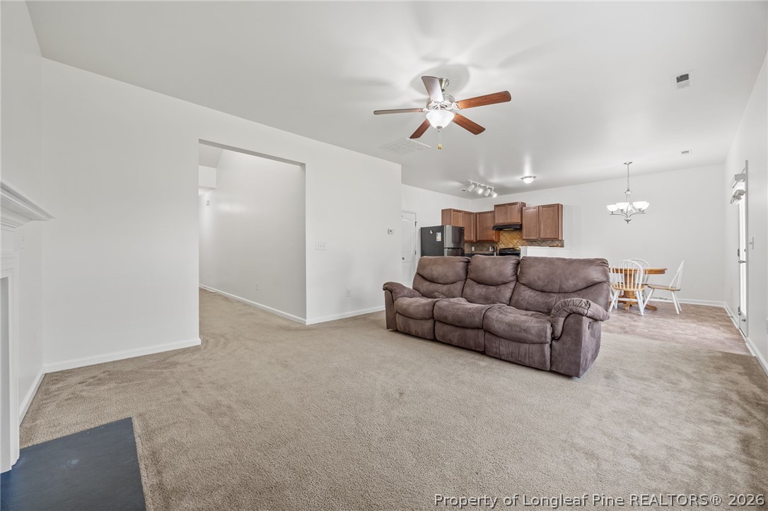 226 River Oak Street Spring Lake, NC 28390 - Photo 14 of 41 a living room with furniture and a chandelier