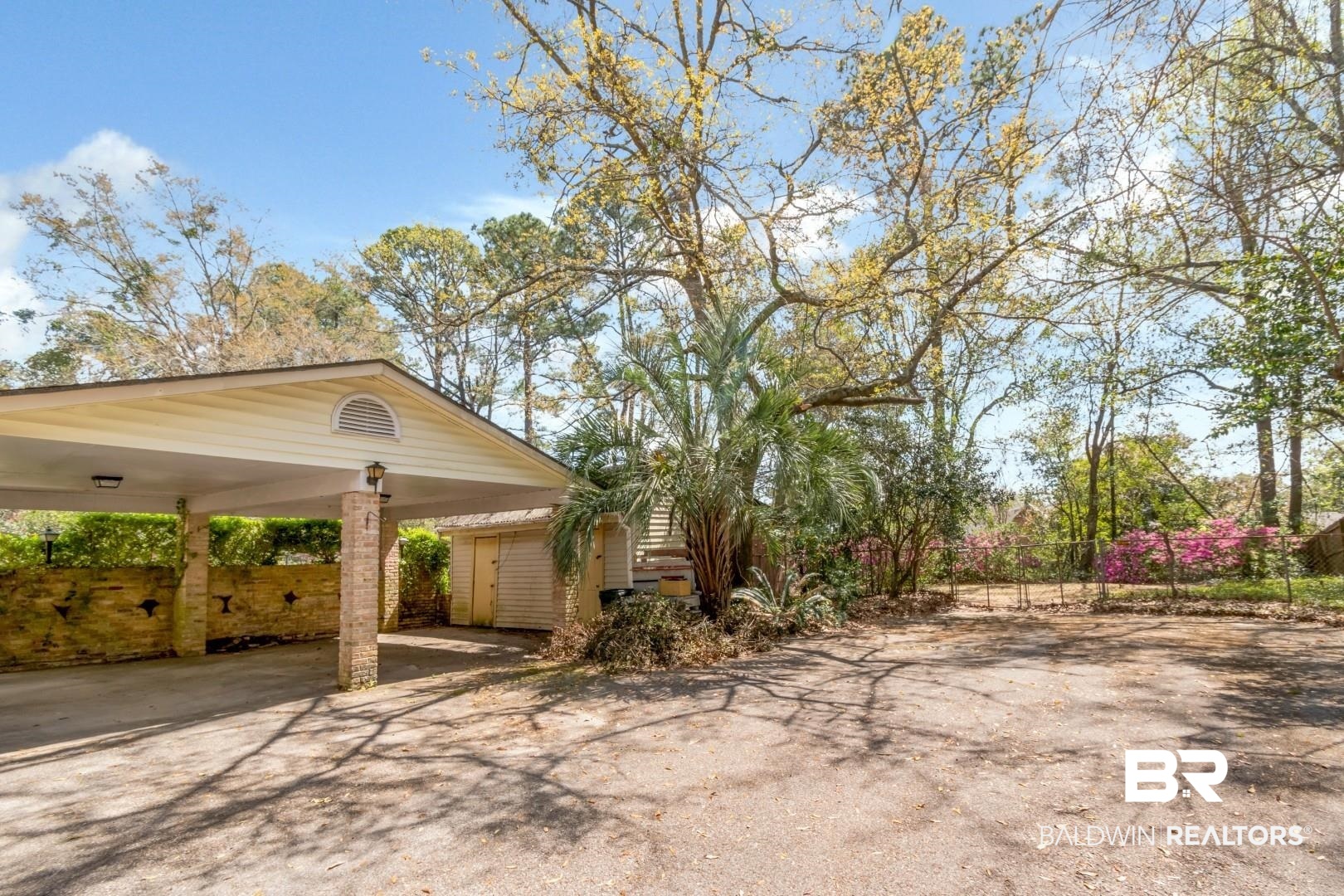 3715 South Conway Drive Mobile, AL 36608 - Photo 17 of 24 View of property exterior with driveway, a carport, and fence