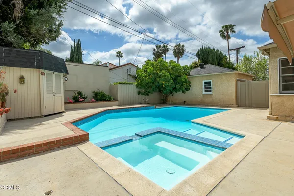a view of a backyard with a small pool