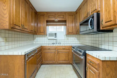a kitchen that has a sink and a stove