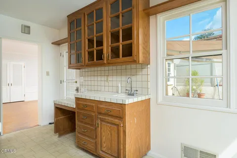 a room with a cabinets and a window