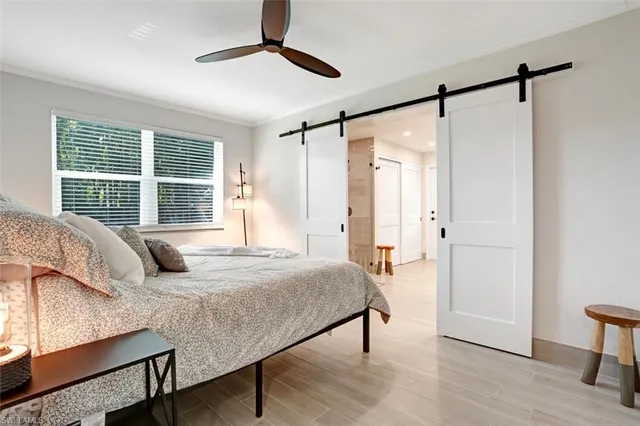 a bedroom with a bed window and a table