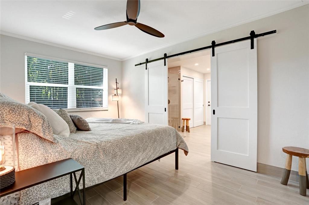 982 13th Street North Naples, FL 34102 - Photo 13 of 29 a bedroom with a bed window and a table