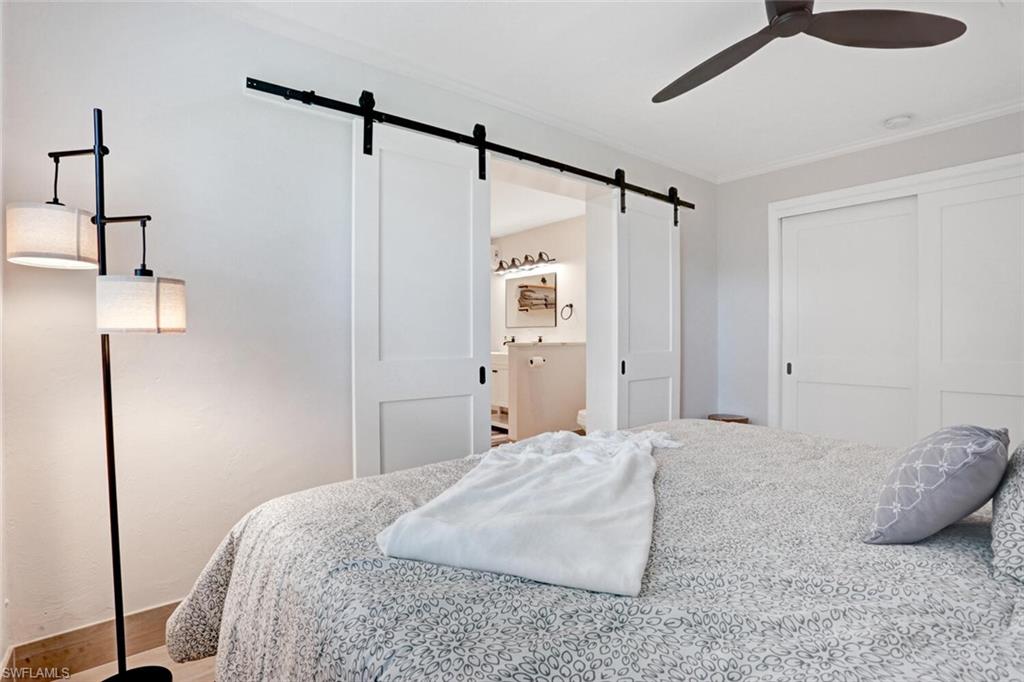 982 13th Street North Naples, FL 34102 - Photo 14 of 29 a bedroom with a bed and a table