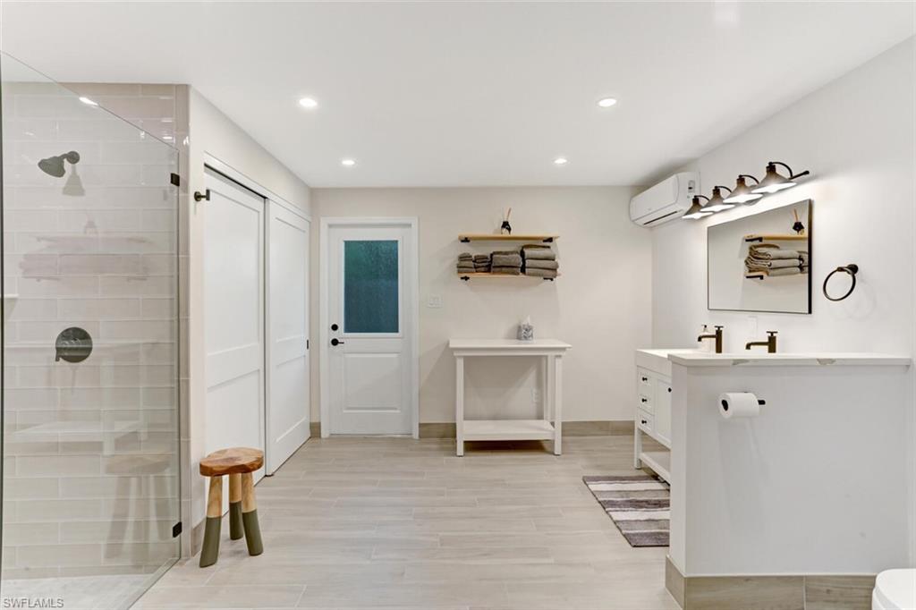 982 13th Street North Naples, FL 34102 - Photo 15 of 29 a bathroom with a sink and a mirror