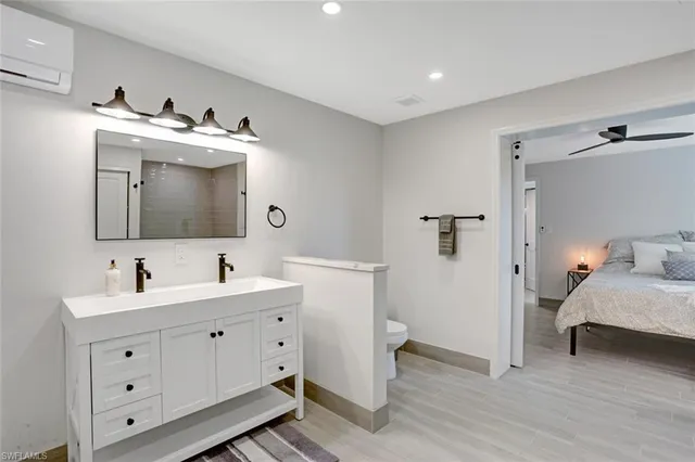 a en suite bathroom with 2 sink toilet and mirror