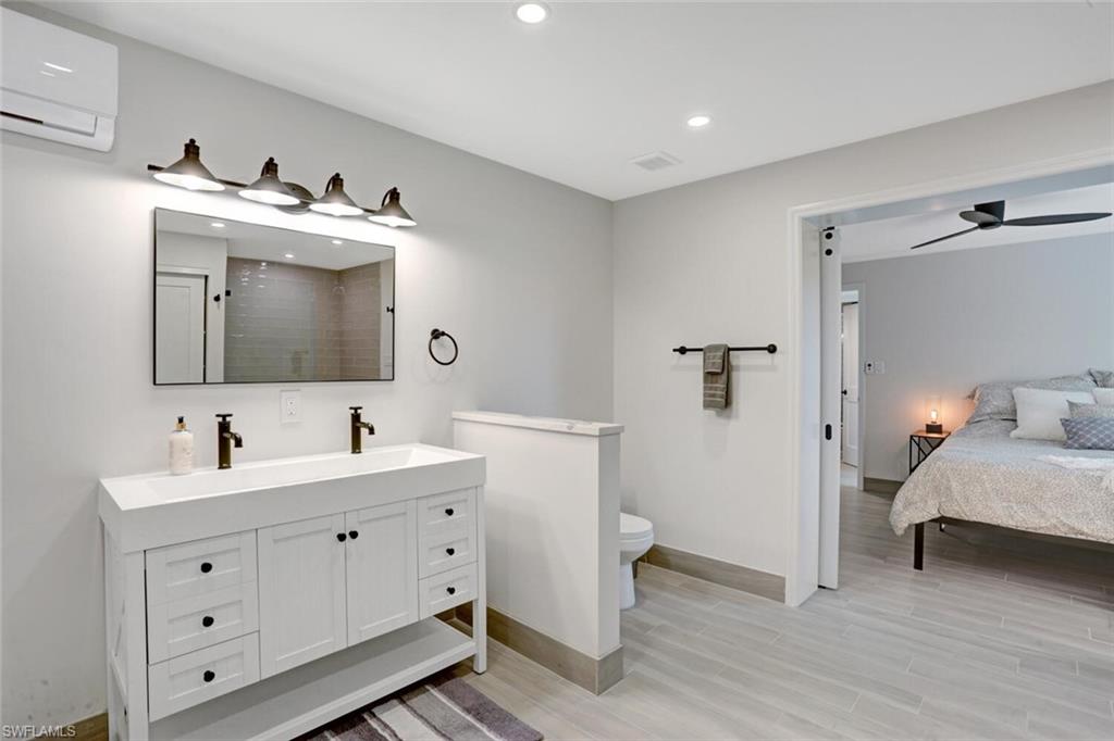 982 13th Street North Naples, FL 34102 - Photo 16 of 29 a en suite bathroom with 2 sink toilet and mirror