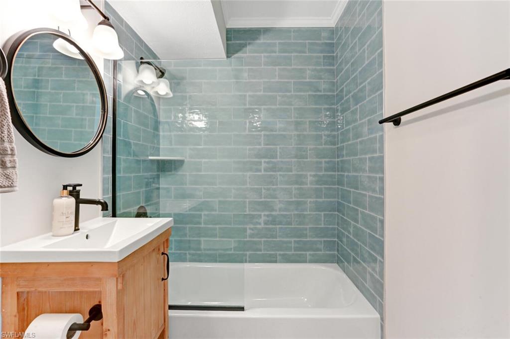 982 13th Street North Naples, FL 34102 - Photo 21 of 29 a bathroom with a sink a toilet and a mirror