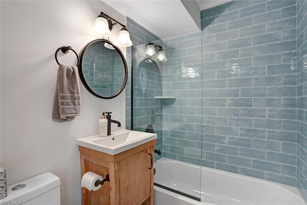 982 13th Street North Naples, FL 34102 - Photo 22 of 29 a bathroom with a sink a toilet and a bathtub