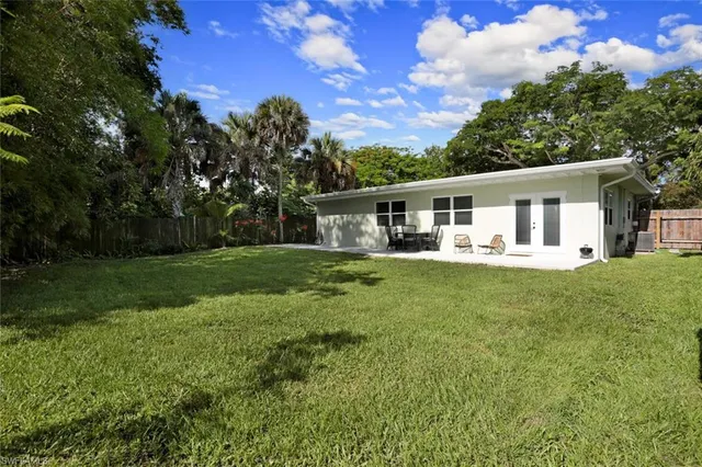 a front view of house with yard and green space