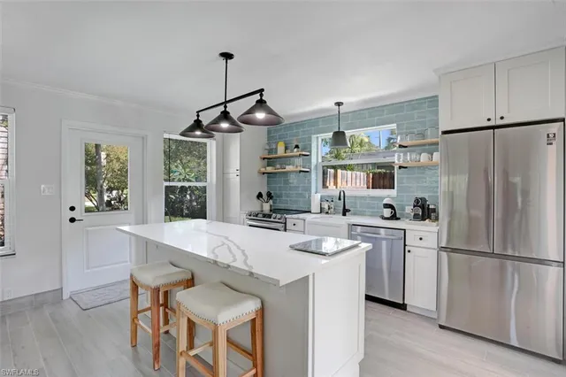 a kitchen with refrigerator cabinets and wooden floor