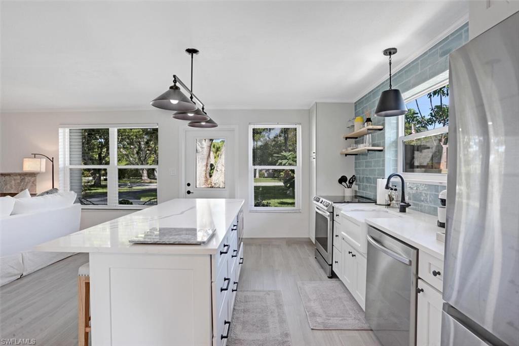 982 13th Street North Naples, FL 34102 - Photo 7 of 29 a large white kitchen with a window