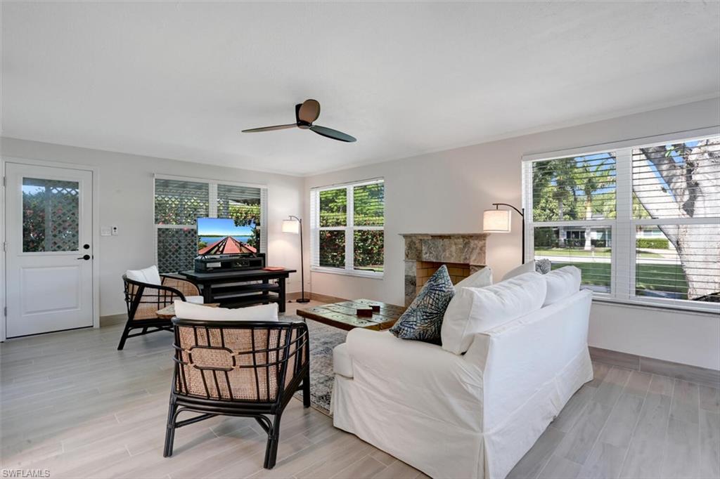 982 13th Street North Naples, FL 34102 - Photo 10 of 29 a living room with furniture and a fireplace
