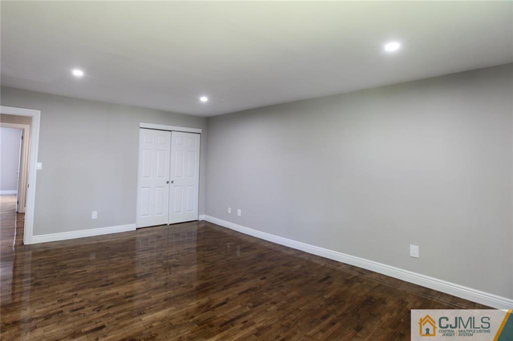 4302 Hana Road Edison, NJ 08817 - Photo 12 of 15 an empty room with wooden floor and windows