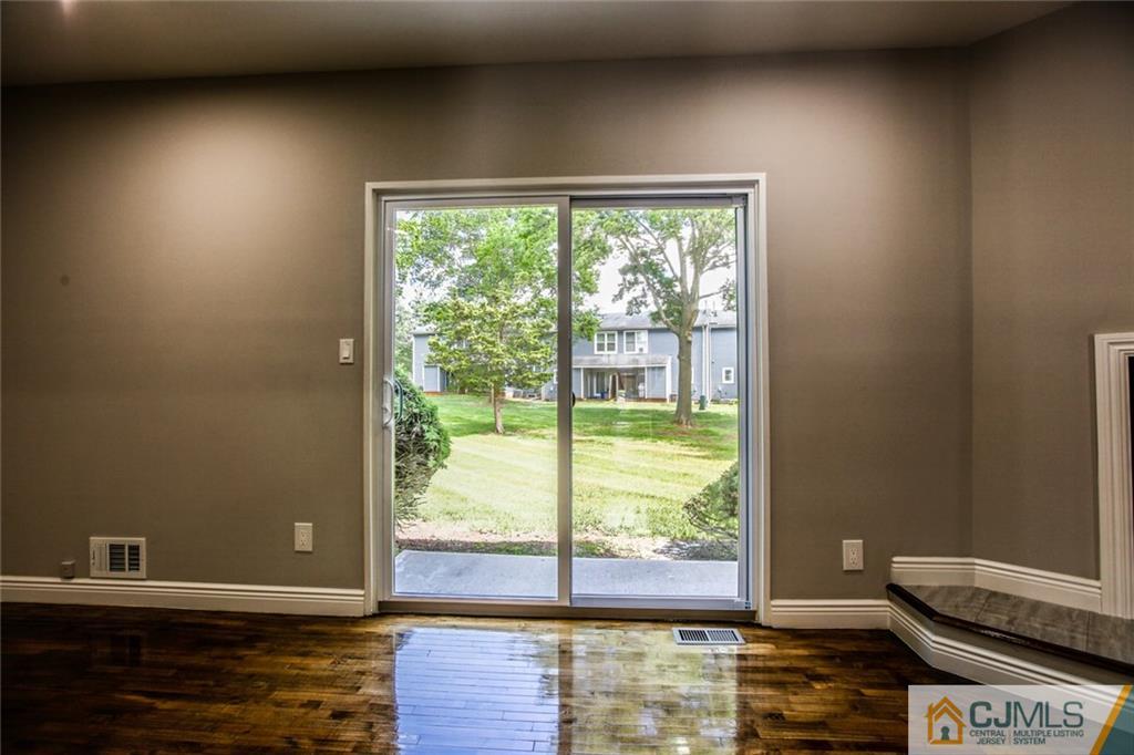 4302 Hana Road Edison, NJ 08817 - Photo 15 of 15 a view of a room that has a bed and wooden floor