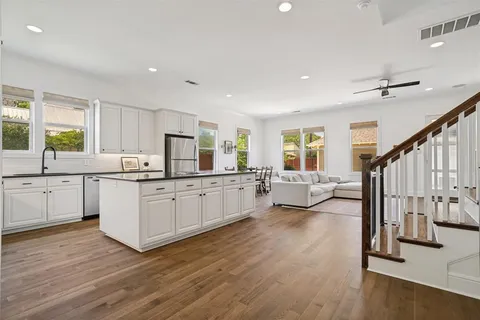 a kitchen with sink stove and cabinets