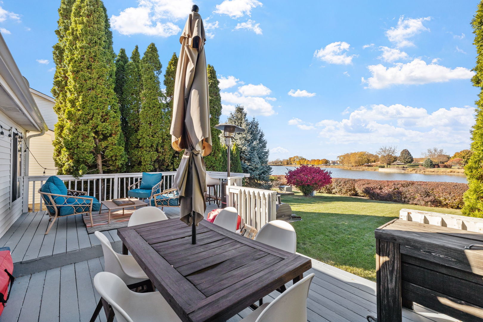 14058 South Hemingway Circle Plainfield, IL 60544 - Photo 18 of 23 a view of a deck with a table and chairs with wooden floor and fence