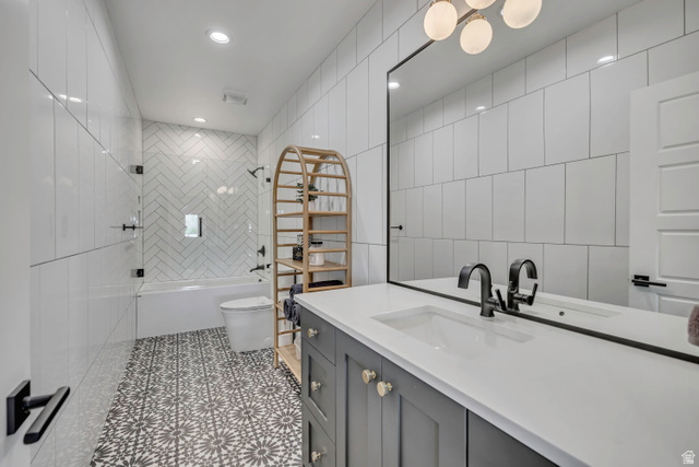 1720 Hillcrest Circle Mapleton, UT 84664 - Photo 73 of 116 Bathroom with vanity, tile walls, tub / shower combination, recessed lighting, and light tile patterned flooring