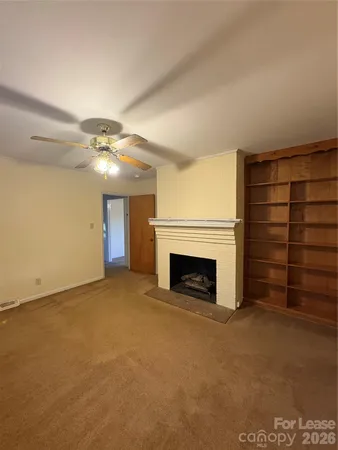 a view of an empty room with a fireplace