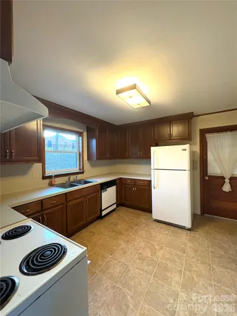 a kitchen with a stove and a refrigerator