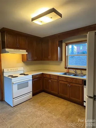 a kitchen with stainless steel appliances granite countertop a stove and a sink