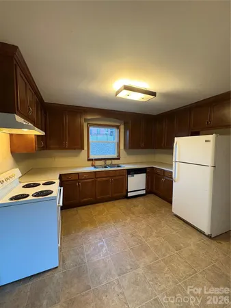 a kitchen with stainless steel appliances a refrigerator and a sink