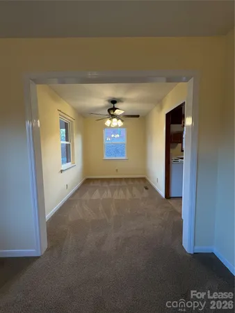 an empty room with a fireplace and painted walls