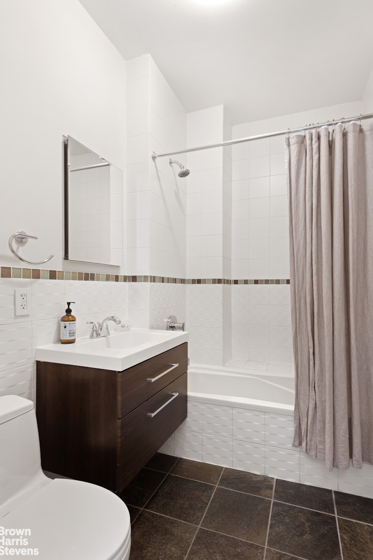 140 West 124th Street, Unit 8A Manhattan, NY 10027 - Photo 10 of 16 a bathroom with a sink a toilet and mirror