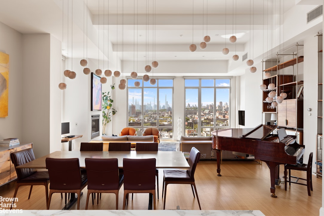 140 West 124th Street, Unit 8A Manhattan, NY 10027 - Photo 2 of 16 a view of a dining room with furniture large windows and wooden floor