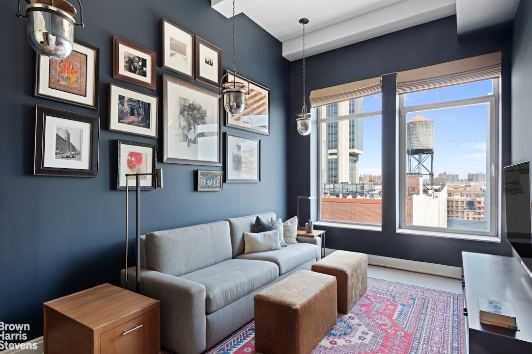 140 West 124th Street, Unit 8A Manhattan, NY 10027 - Photo 9 of 16 a living room with furniture two windows and a wooden floor