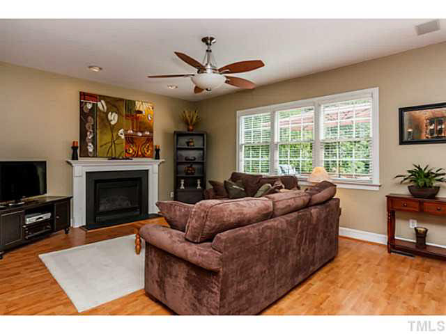 12308 Galway Drive Raleigh, NC 27613 - Photo 5 of 25 Living room is spacious & open to the kitchen which is wonderful for family & friends. FYI there is cable connection behind the large painting above the gas log fireplace.