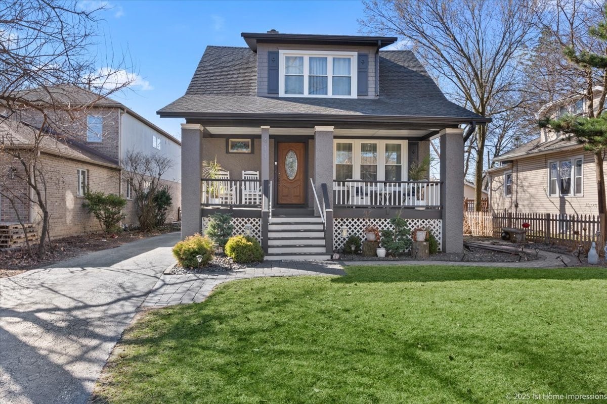 411 Herrick Road Riverside, IL 60546 - Photo 1 of 37 a front view of a house with garden and porch