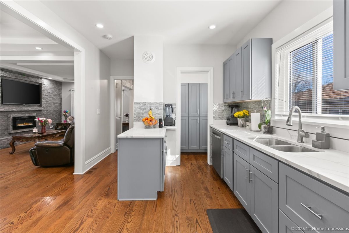 411 Herrick Road Riverside, IL 60546 - Photo 12 of 37 a kitchen with a refrigerator a stove top oven a sink dishwasher and wooden floor