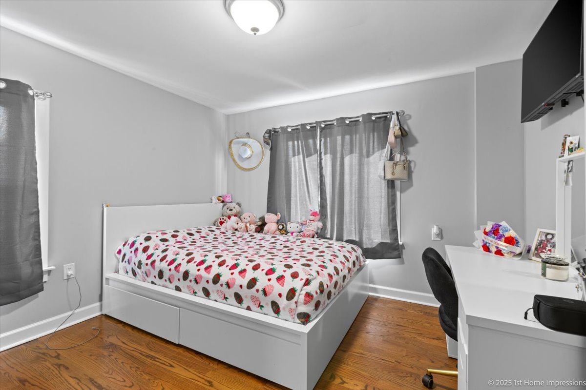 411 Herrick Road Riverside, IL 60546 - Photo 19 of 37 a bedroom with a bed and a flat screen tv