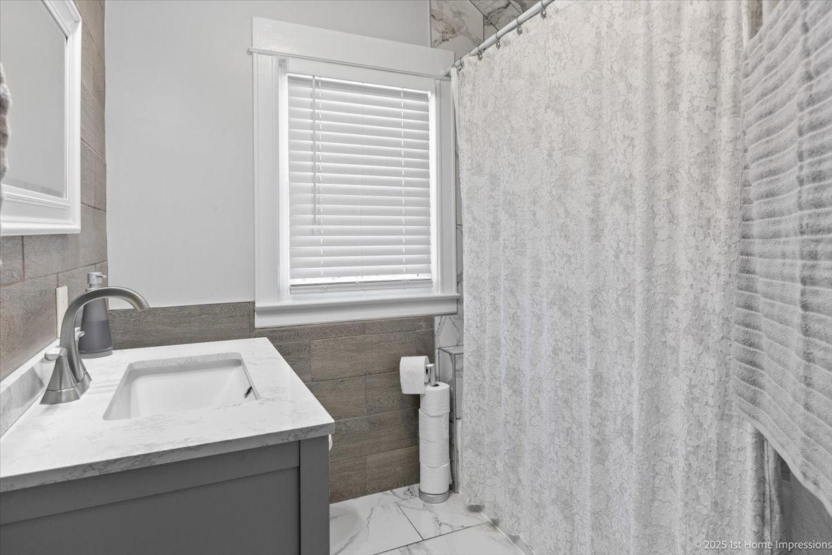 411 Herrick Road Riverside, IL 60546 - Photo 21 of 37 a bathroom with a sink and a mirror