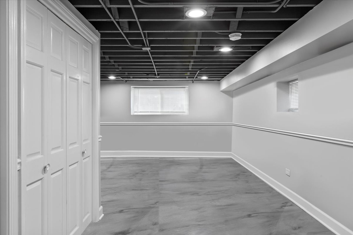 411 Herrick Road Riverside, IL 60546 - Photo 24 of 37 a view of an empty room with wooden floor and windows