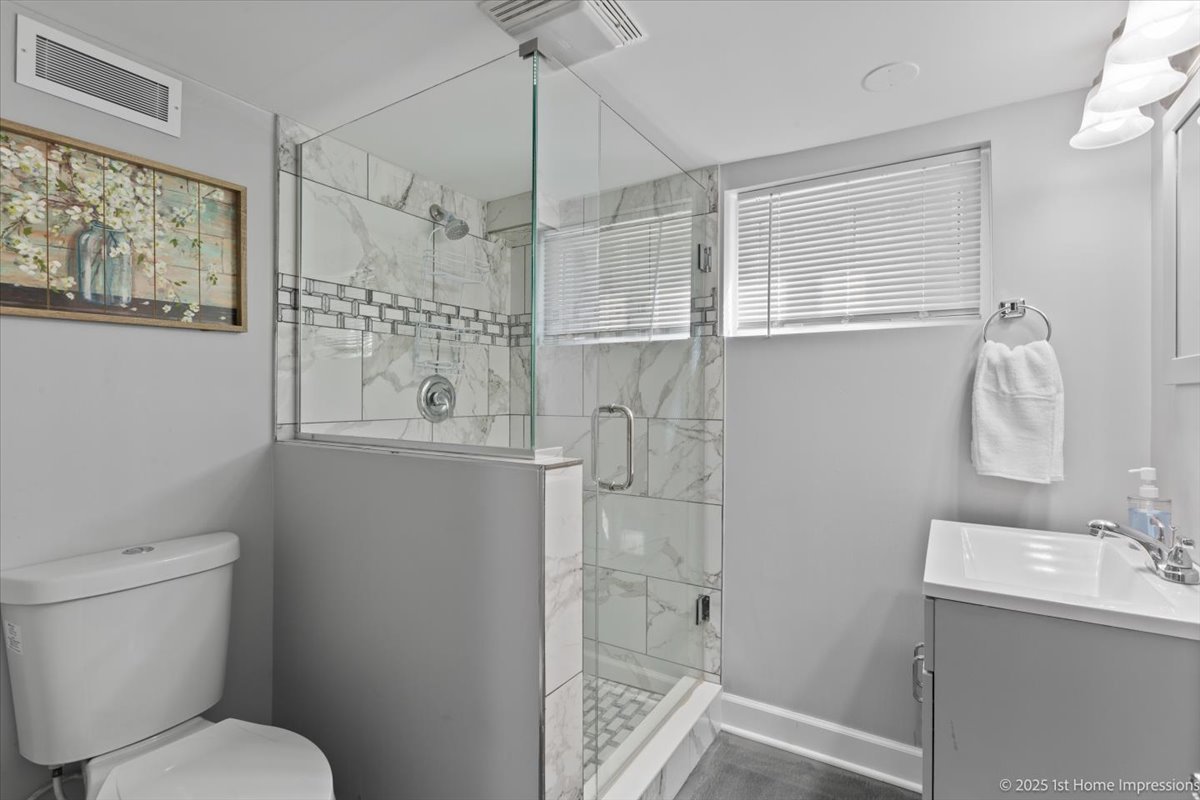 411 Herrick Road Riverside, IL 60546 - Photo 25 of 37 a bathroom with a shower toilet and sink
