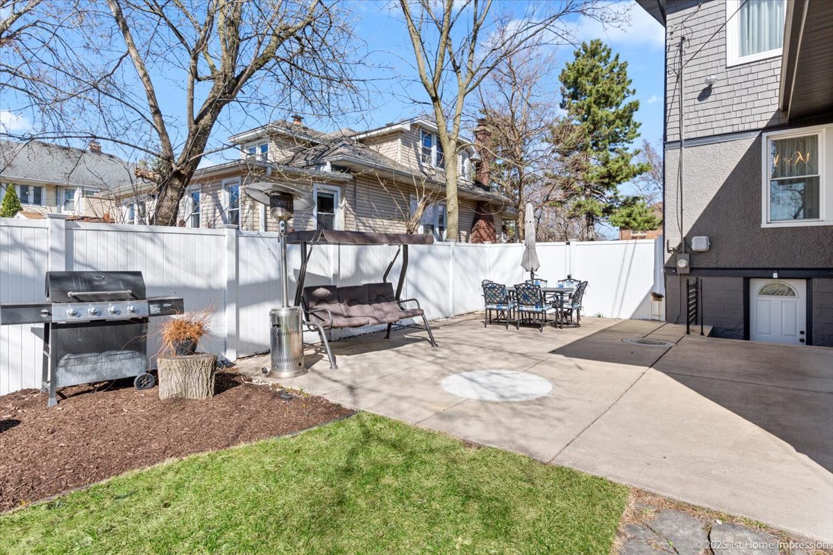 411 Herrick Road Riverside, IL 60546 - Photo 29 of 37 a view of a backyard with table and chairs and a fire pit