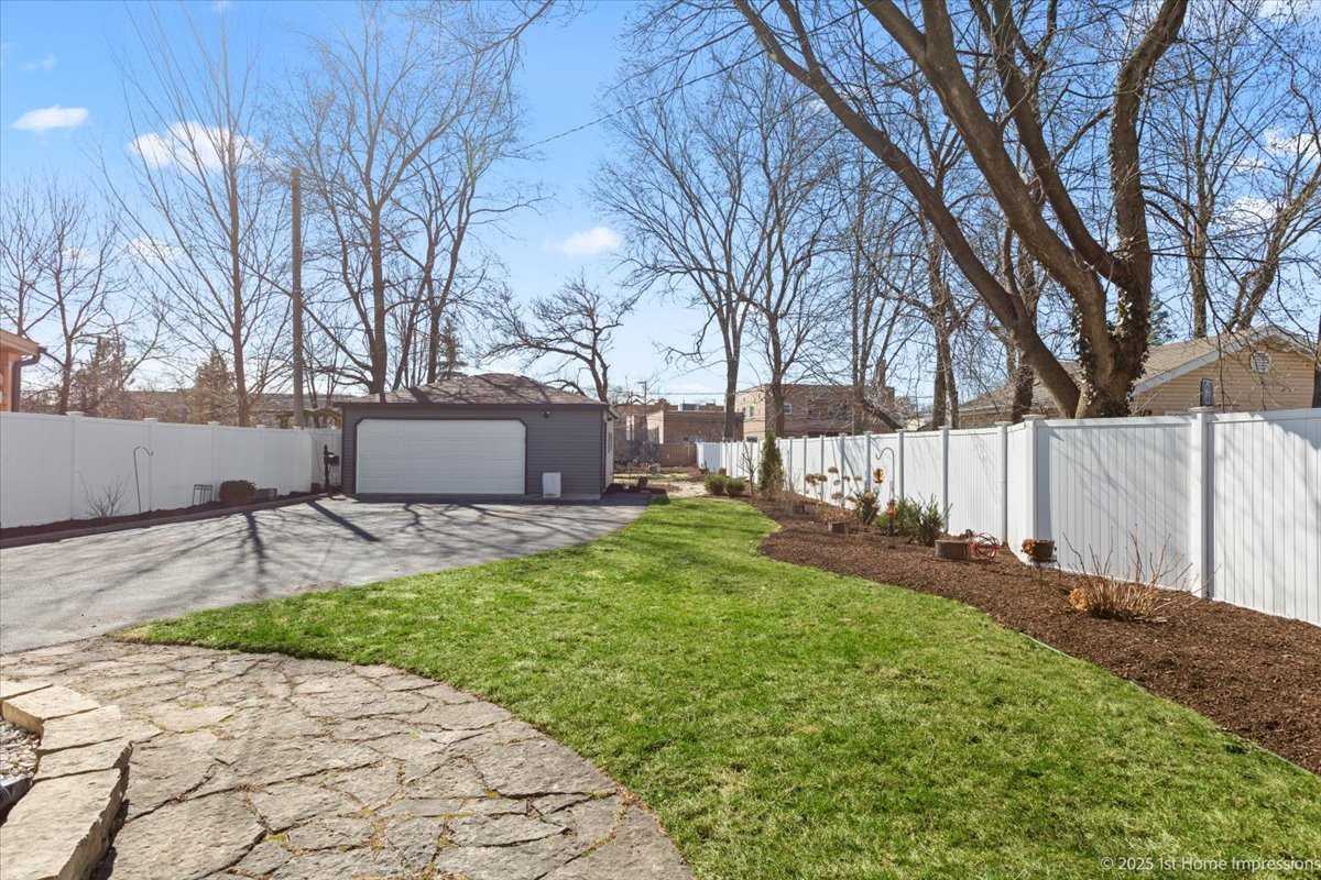 411 Herrick Road Riverside, IL 60546 - Photo 32 of 37 a backyard of a house with table and chairs