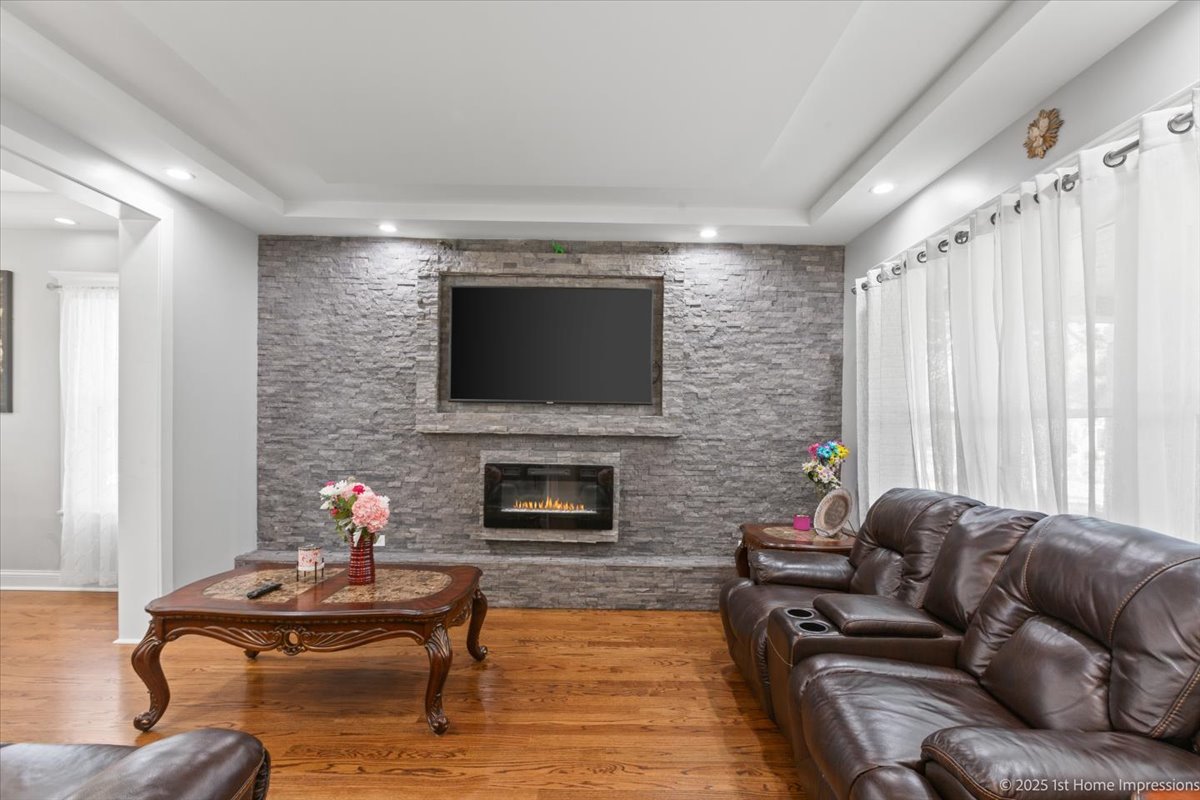 411 Herrick Road Riverside, IL 60546 - Photo 5 of 37 a living room with furniture a flat screen tv and a fireplace