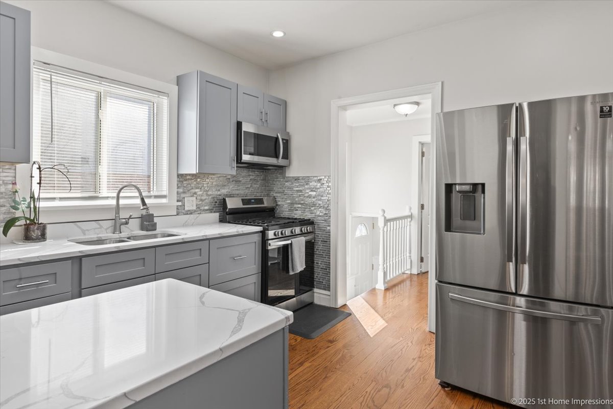 411 Herrick Road Riverside, IL 60546 - Photo 10 of 37 a kitchen with a refrigerator stove and sink