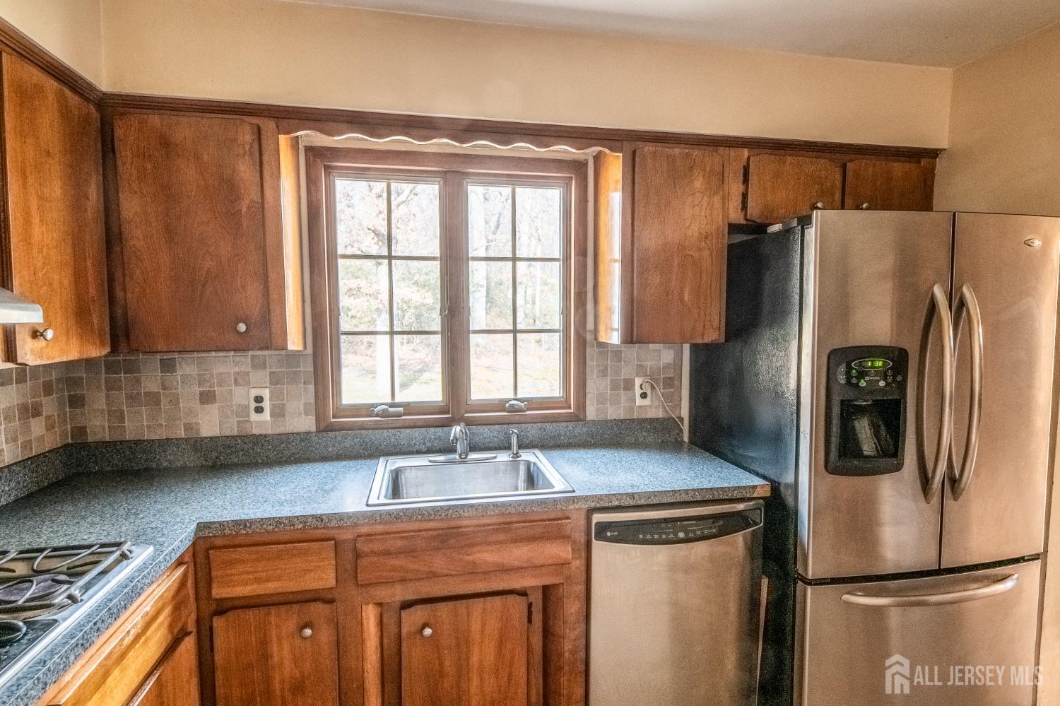12 Francis Road East Brunswick, NJ 08816 - Photo 11 of 66 a kitchen with stainless steel appliances granite countertop a refrigerator a sink and white cabinets