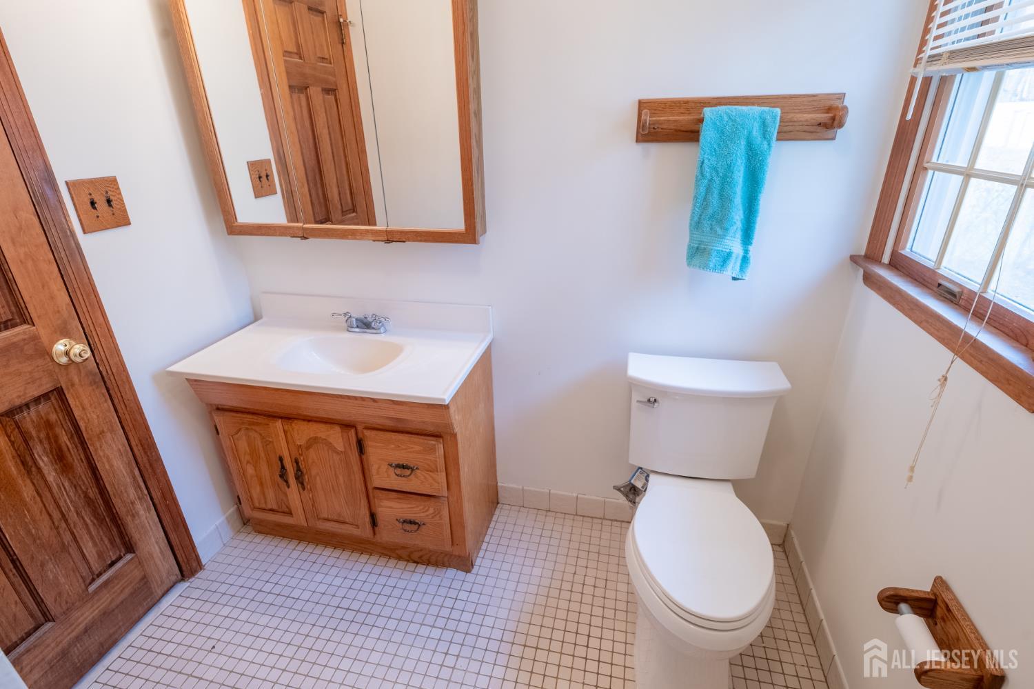 12 Francis Road East Brunswick, NJ 08816 - Photo 22 of 66 a bathroom with a toilet sink and mirror