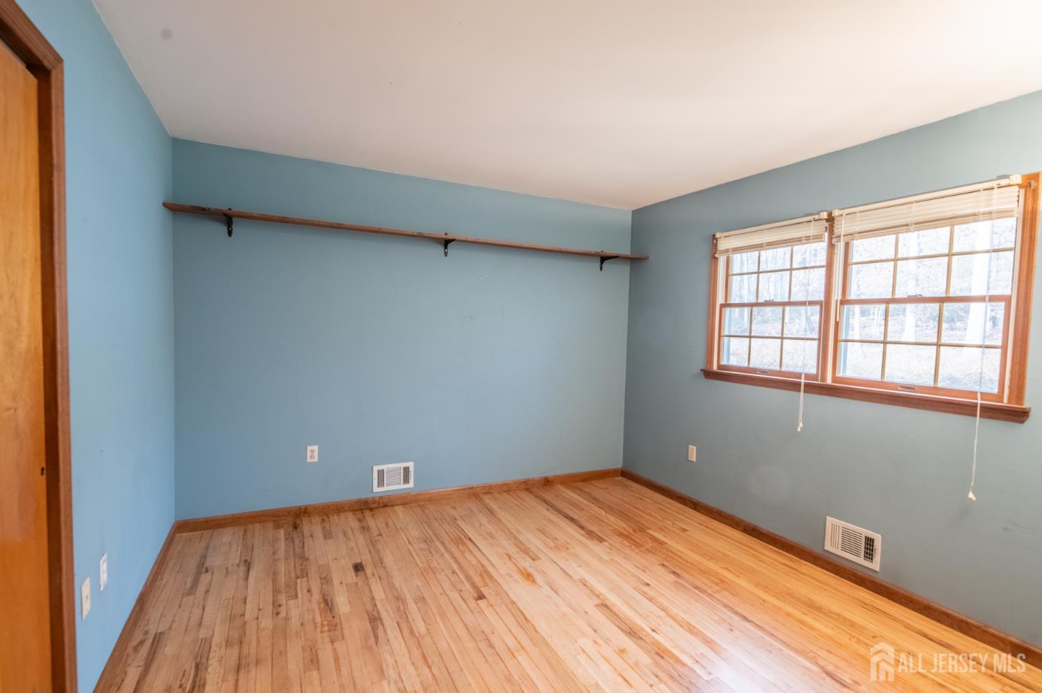12 Francis Road East Brunswick, NJ 08816 - Photo 23 of 66 an empty room with wooden floor and windows