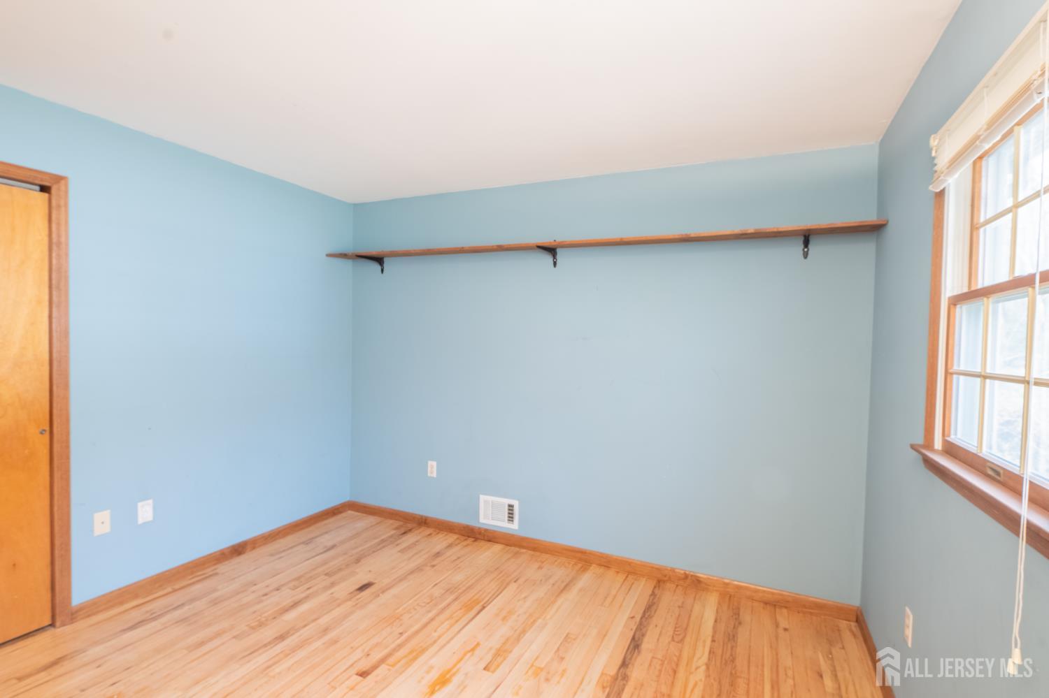 12 Francis Road East Brunswick, NJ 08816 - Photo 26 of 66 a view of empty room with wooden floor and fan