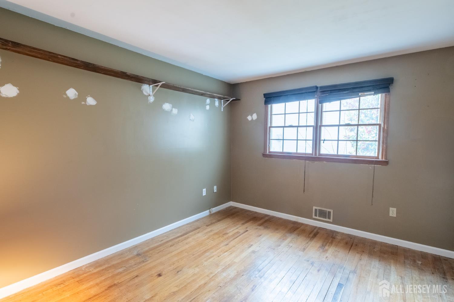 12 Francis Road East Brunswick, NJ 08816 - Photo 28 of 66 an empty room with wooden floor and windows