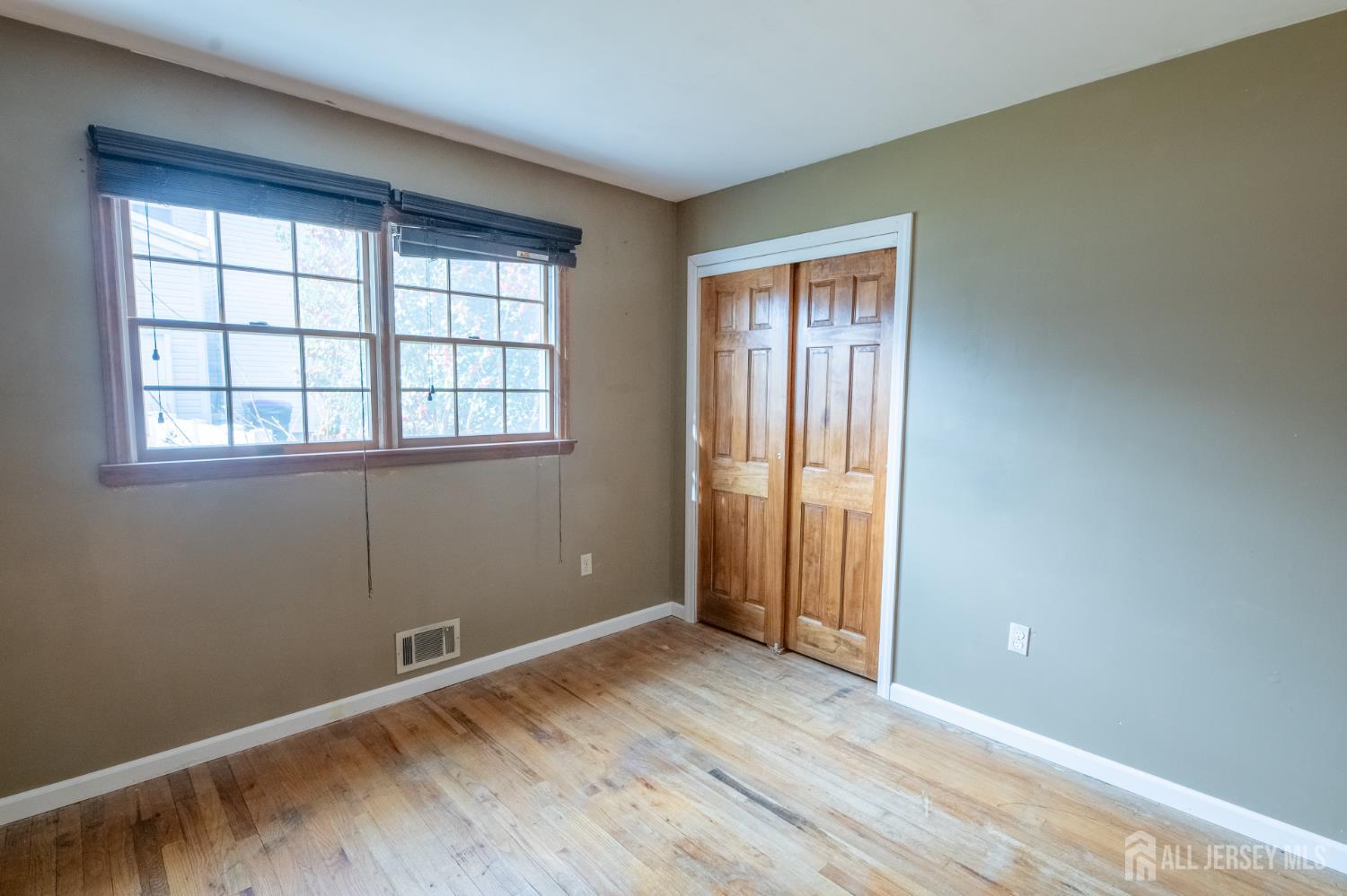 12 Francis Road East Brunswick, NJ 08816 - Photo 29 of 66 an empty room with wooden floor and windows