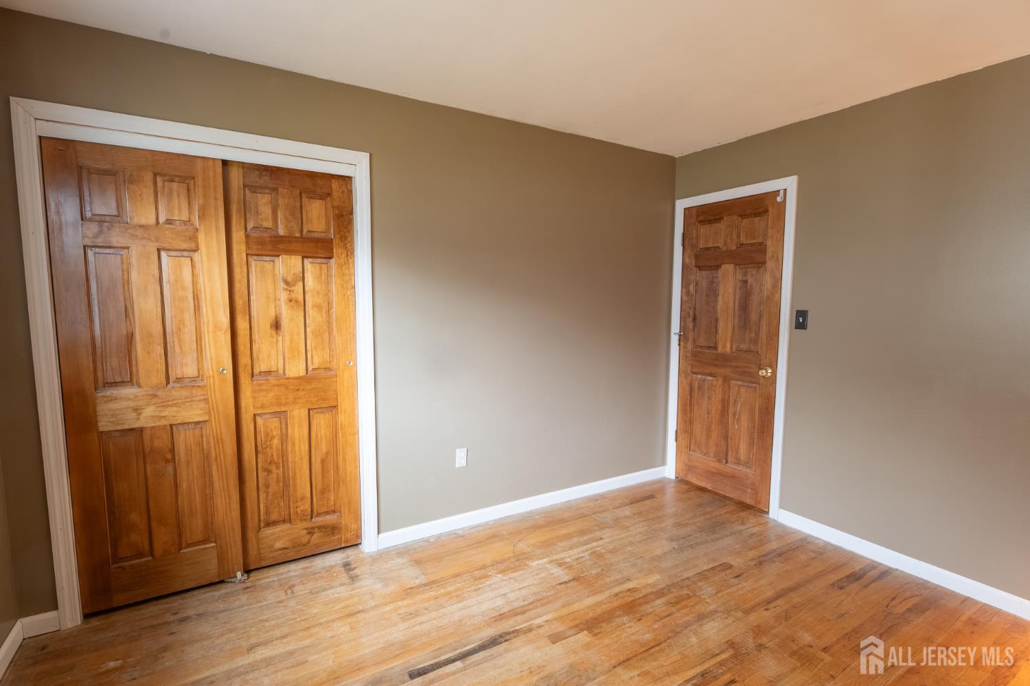 12 Francis Road East Brunswick, NJ 08816 - Photo 31 of 66 a view of an empty room with wooden floor and a window
