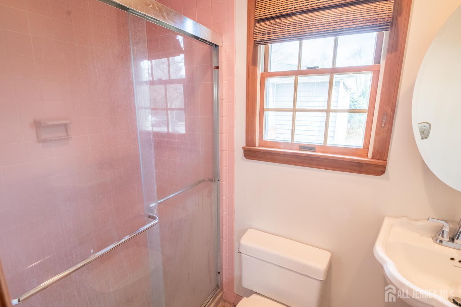 12 Francis Road East Brunswick, NJ 08816 - Photo 37 of 66 a bathroom with a toilet a sink a bath tub and a window