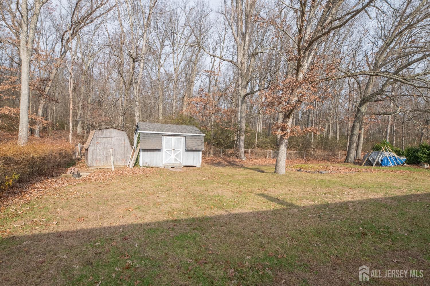 12 Francis Road East Brunswick, NJ 08816 - Photo 58 of 66 a backyard of a house with large trees and outdoor space